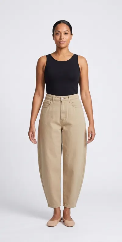 AI try-on example: the same woman in barrel trousers in stone twill with a black tank top